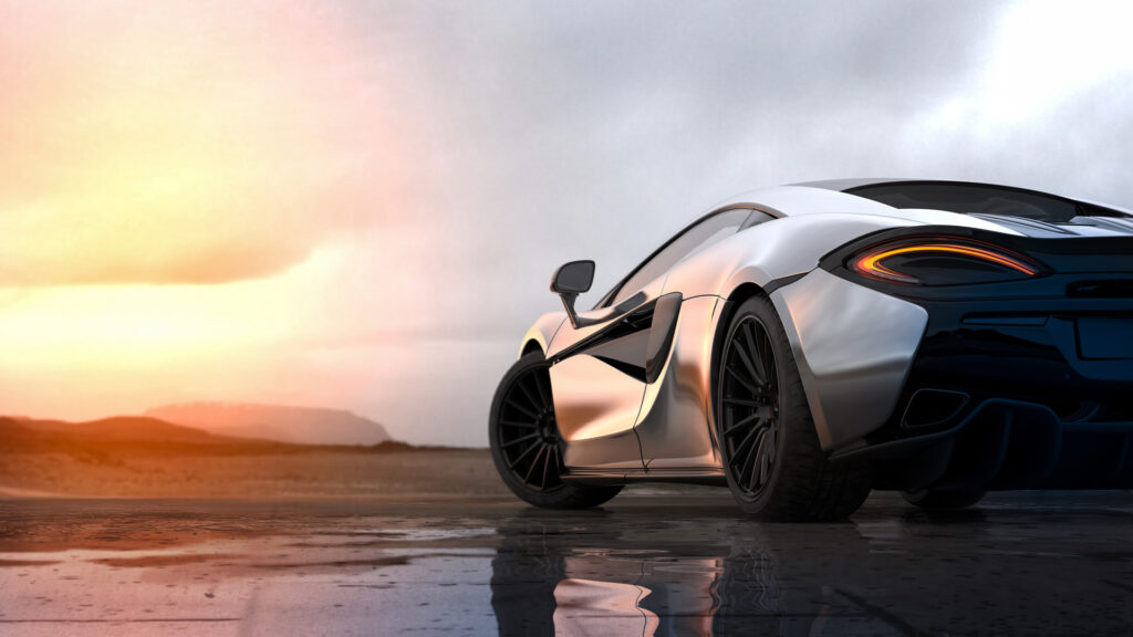 Rear view of silver sports car on wet road at sunset for Steve Kouli Smash