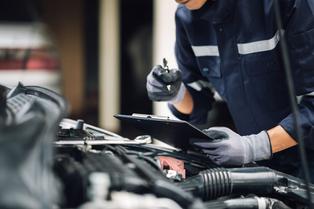 Steve Koulis Smash Repairs mechanic inspecting engine during professional car service and maintenance