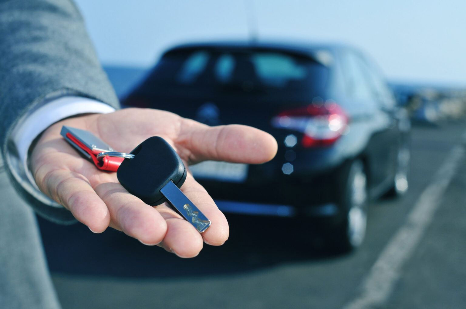Man handing replacement vehicle key at Steve Koulis Smash Repairs service centre
